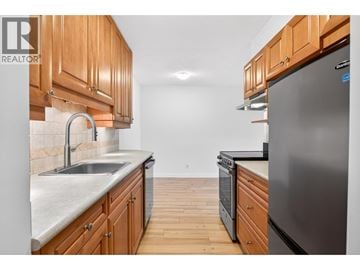 North Vancouver apartment for rent - A kitchen with wooden cabinets and a stainless steel refrigerator.