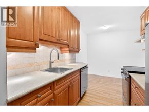 North Vancouver apartment for rent - A kitchen with wooden cabinets and a sink.