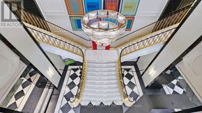 Toronto (Bay Street Corridor) condo for rent - A chandelier hangs from the ceiling in a hallway with black and white checkered flooring.