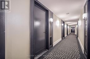 Toronto (Bay Street Corridor) condo for rent - A hallway with a carpeted floor and a series of doors.