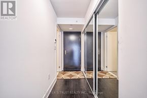 Toronto (Bay Street Corridor) condo for rent - A hallway with a wooden floor and white walls.
