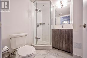 Toronto (Bay Street Corridor) condo for rent - A white toilet sits next to a walk-in shower in a bathroom.