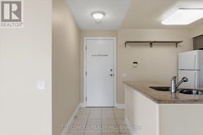 Toronto (Willowdale East) condo for rent - A kitchen area with a sink and a refrigerator.