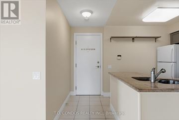 Toronto (Willowdale East) condo for rent - A kitchen area with a sink and a refrigerator.