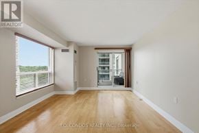 Toronto (Willowdale East) condo for rent - A room with a wooden floor and a sliding glass door leading to a balcony.