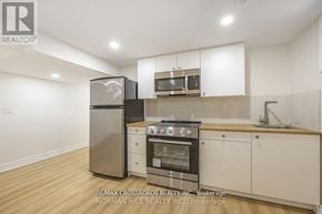 Toronto (Tam O'shanter-Sullivan) apartment for rent - A kitchen with white cabinets and a stainless steel refrigerator.
