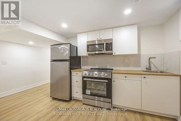 Toronto (Tam O'shanter-Sullivan) apartment for rent - A kitchen with white cabinets and a stainless steel refrigerator.