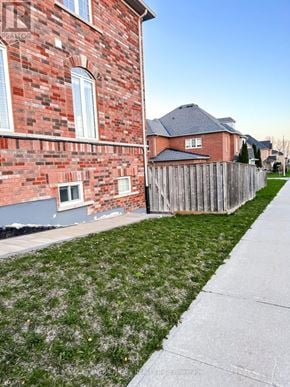 Richmond Hill (Westbrook) apartment for rent - A red brick house with a wooden fence and a green lawn.