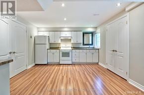 Markham (Wismer) apartment for rent - A kitchen with white cabinets and a wooden floor.