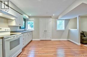 Markham (Wismer) apartment for rent - A kitchen with white appliances and wooden floors.