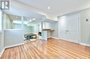 Markham (Wismer) apartment for rent - A spacious room with wooden flooring and white walls.