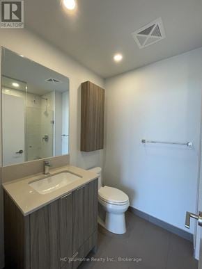 Mississauga (City Centre) condo for rent - A bathroom with a toilet, sink, and mirror.