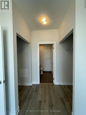Mississauga (City Centre) condo for rent - A hallway with a door at the end and a sign on the wall.