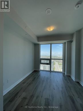 Mississauga (City Centre) condo for rent - A spacious room with a view of the highway outside the window.
