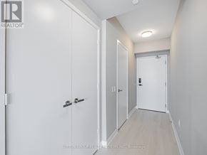 Mississauga (City Centre) condo for rent - A hallway with white doors and a brokerage sign.