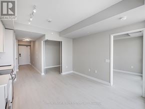 Mississauga (City Centre) condo for rent - A spacious room with a doorway leading to another room.