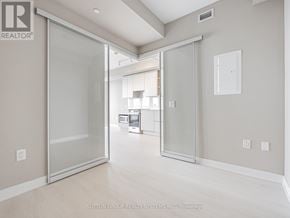 Mississauga (City Centre) condo for rent - A room with a glass door leading to another room.