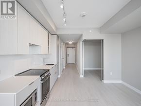 Mississauga (City Centre) condo for rent - A modern kitchen with white cabinets and a stainless steel stove.