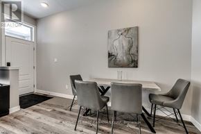 London North (North R) condo for rent - A dining room with a table and chairs and a painting on the wall.