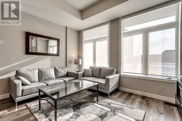 London North (North R) condo for rent - A living room with a grey couch and a glass coffee table.
