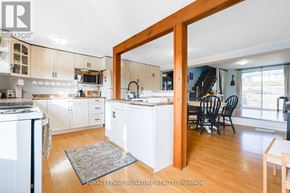 Whitchurch-Stouffville apartment for rent - A kitchen with white cabinets and a wooden door frame.