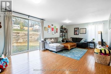Whitchurch-Stouffville apartment for rent - A living room with a white couch and a wooden floor.