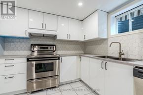 Markham (Village Green-South Unionville) apartment for rent - A kitchen with white cabinets and a stainless steel oven.