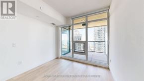 Toronto (Waterfront Communities) condo for rent - A white room with a sliding glass door leading to a balcony.