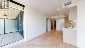Toronto (Waterfront Communities) condo for rent - A spacious room with a glass door leading to a balcony.