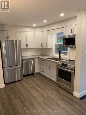 Barrie (Codrington) apartment for rent - A kitchen with a stainless steel refrigerator, dishwasher, and oven.