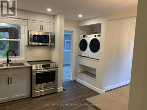 Barrie (Codrington) apartment for rent - A modern kitchen with stainless steel appliances and white cabinets.