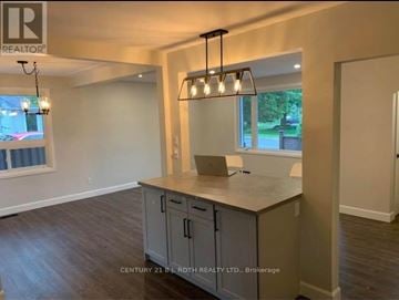 Barrie (Codrington) apartment for rent - A kitchen area with a counter and cabinets.