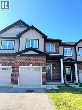 Kitchener townhouse for rent - A house with a garage and a driveway in front.