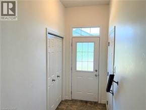 Kitchener townhouse for rent - A white door is in a hallway with a window above it.