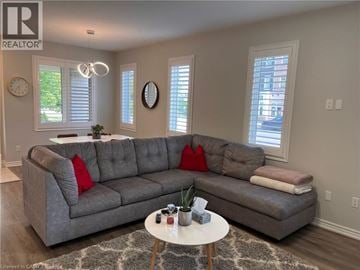 Kitchener townhouse for rent - A living room with a grey sofa and a white coffee table.
