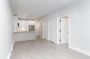 Langley apartment for rent - A white kitchen with a refrigerator, microwave, and oven.
