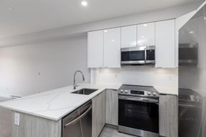 Langley apartment for rent - A modern kitchen with a white countertop and stainless steel appliances.