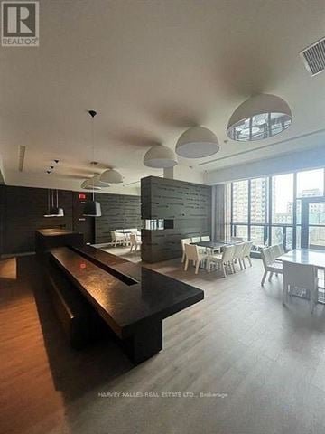 Toronto (Church-Yonge Corridor) condo for rent - A modern dining area with a long table and chairs.