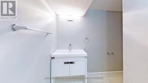 Toronto (Dufferin Grove) apartment for rent - A white bathroom with a sink and a cabinet.