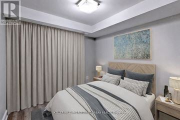 Toronto (Dufferin Grove) apartment for rent - A bedroom with a large bed and a painting on the wall.