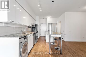 Toronto (Bayview Village) condo for rent - A modern kitchen with white cabinets and stainless steel appliances.