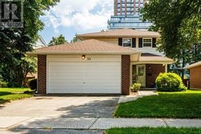 Toronto (Tam O'shanter-Sullivan) apartment for rent - A two-car garage with a brick facade and a white door.