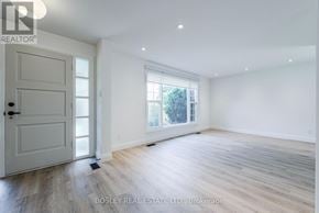 Toronto (Tam O'shanter-Sullivan) apartment for rent - A spacious room with a door and a window.