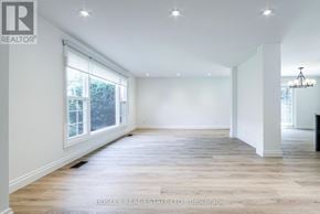 Toronto (Tam O'shanter-Sullivan) apartment for rent - A spacious room with wooden flooring and a large window.