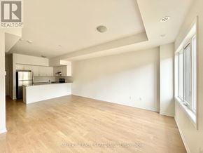 Oshawa (Windfields) townhouse for rent - A spacious room with wooden flooring and white walls.