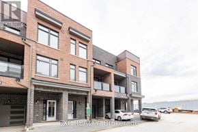 Pickering (Village East) townhouse for rent - A building with the text EXP REALTY, Brokerage on it.
