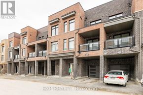 Pickering (Village East) townhouse for rent - A white car is parked in front of a brick building.