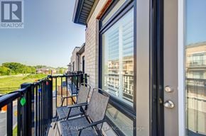 Ajax (South East) townhouse for rent - A balcony with a chair and a table is shown.