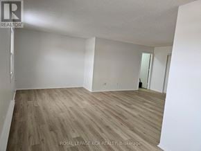 Aurora (Hills Of St Andrew) apartment for rent - A room with wooden flooring and white walls, with a door visible in the background.