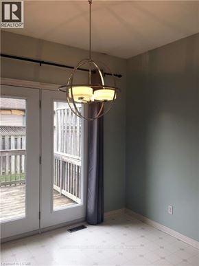 London North (North B) townhouse for rent - A room with a grey wall and a chandelier hanging from the ceiling.